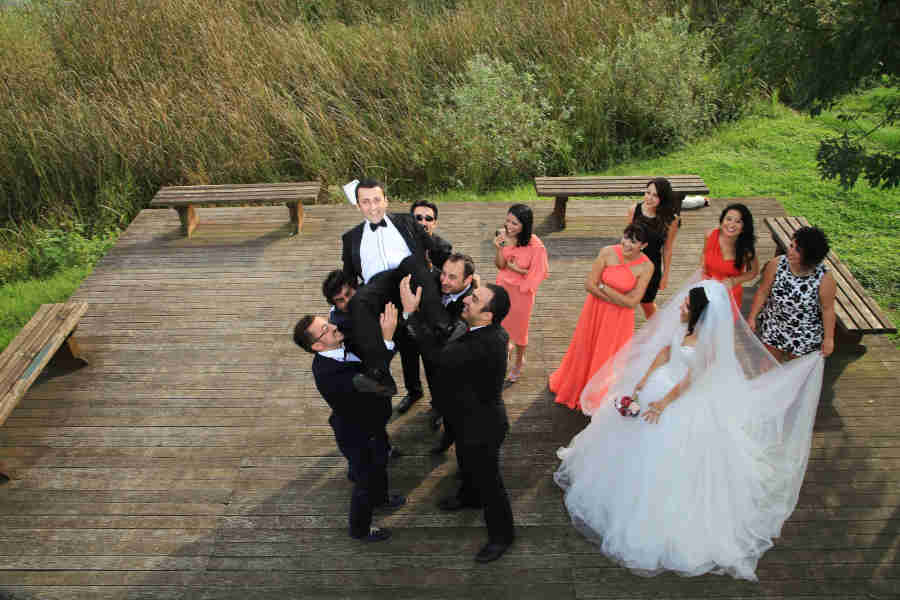 photo-of-friends-celebrating-the-marriage-occation-with-bride-and-groom