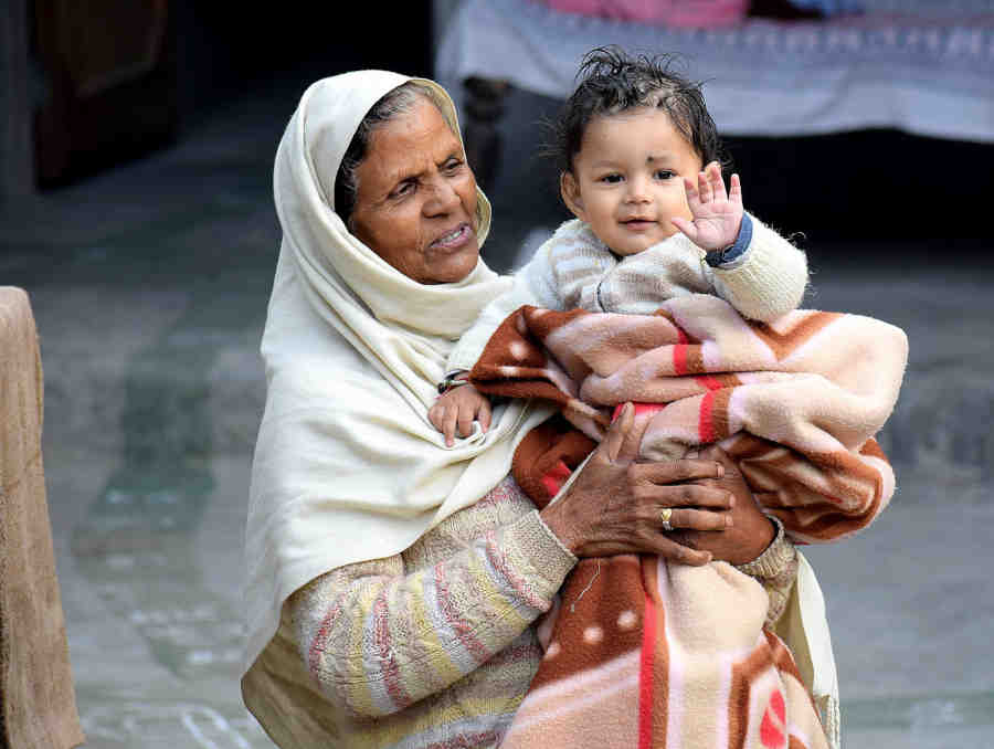 Indian-grandmother-holding-her-beautiful-grandchild-as-a-reprecentation-of-helping-hand-of-the-family.